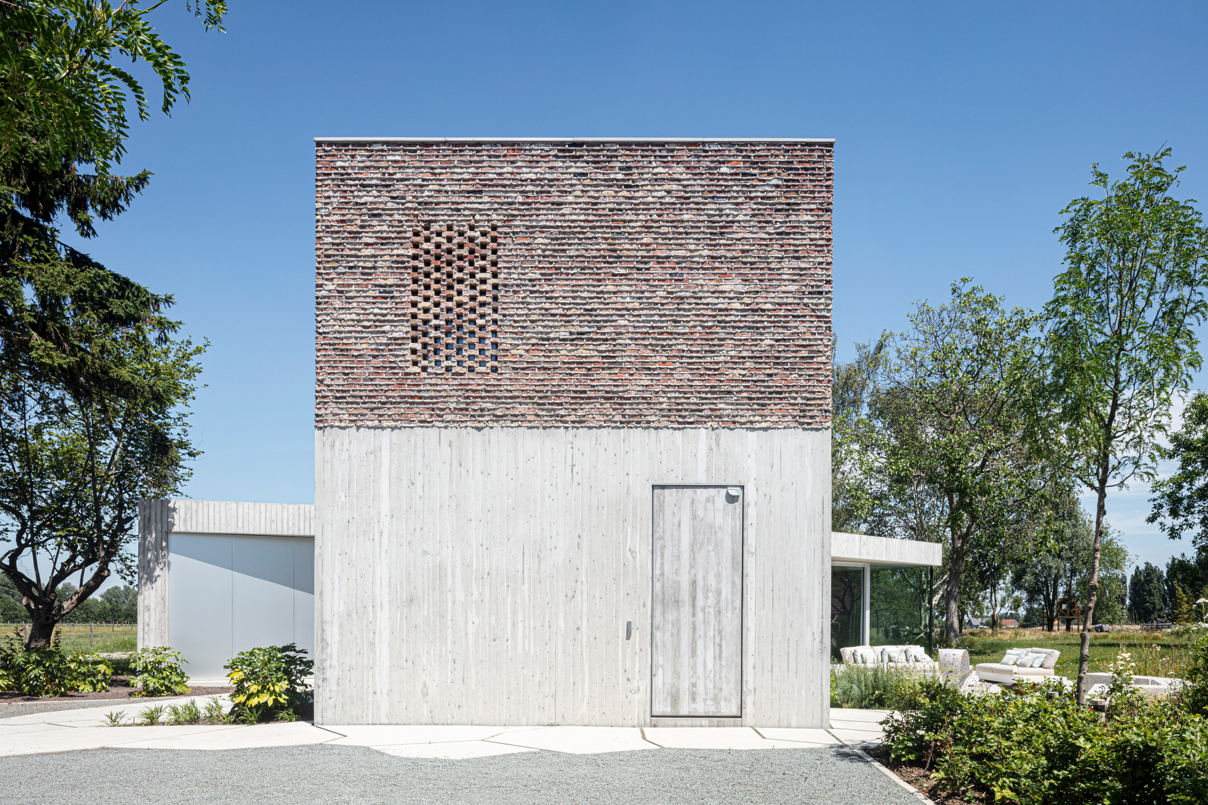 Brick and concrete was used across the exterior of House Dede to create texture