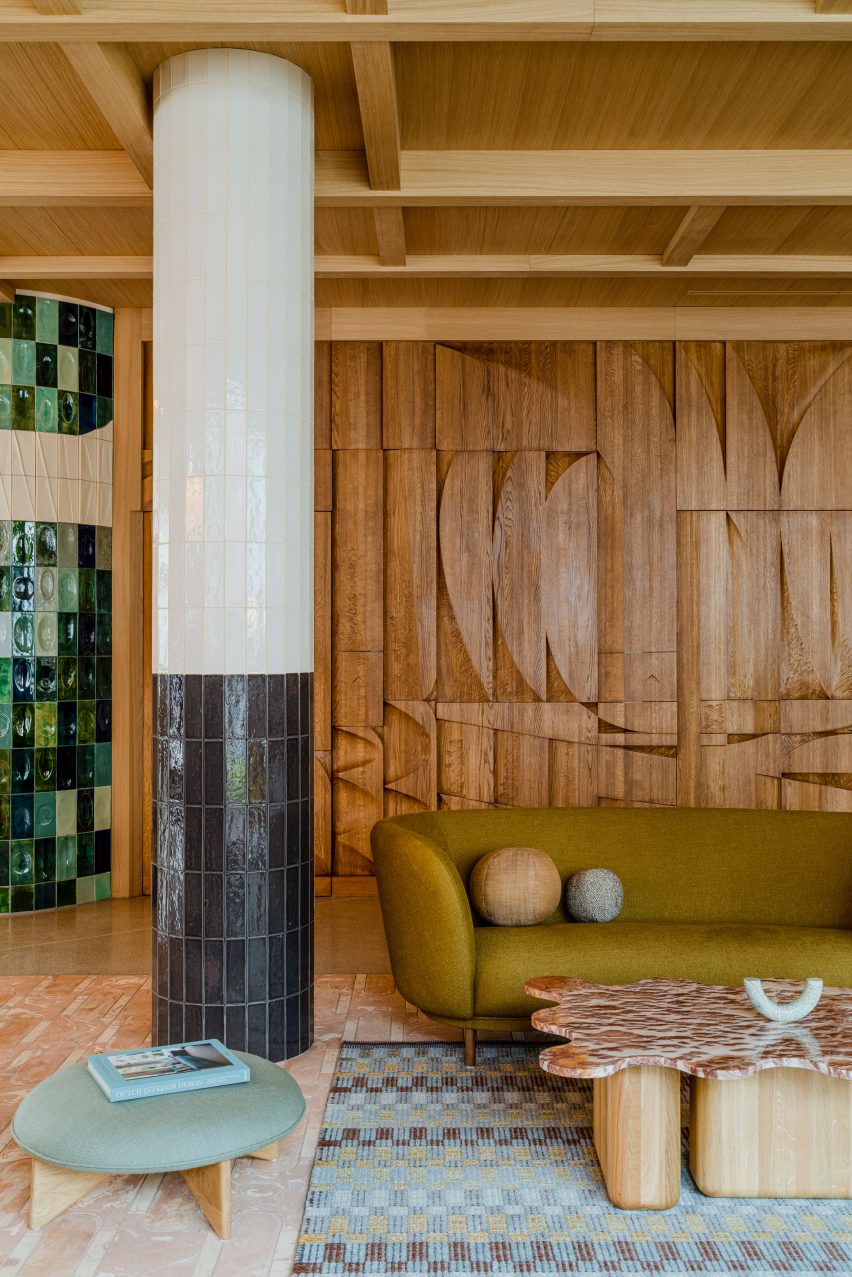 Tiled pillar and bar-relief wall in hotel interior by Studio Paradowski