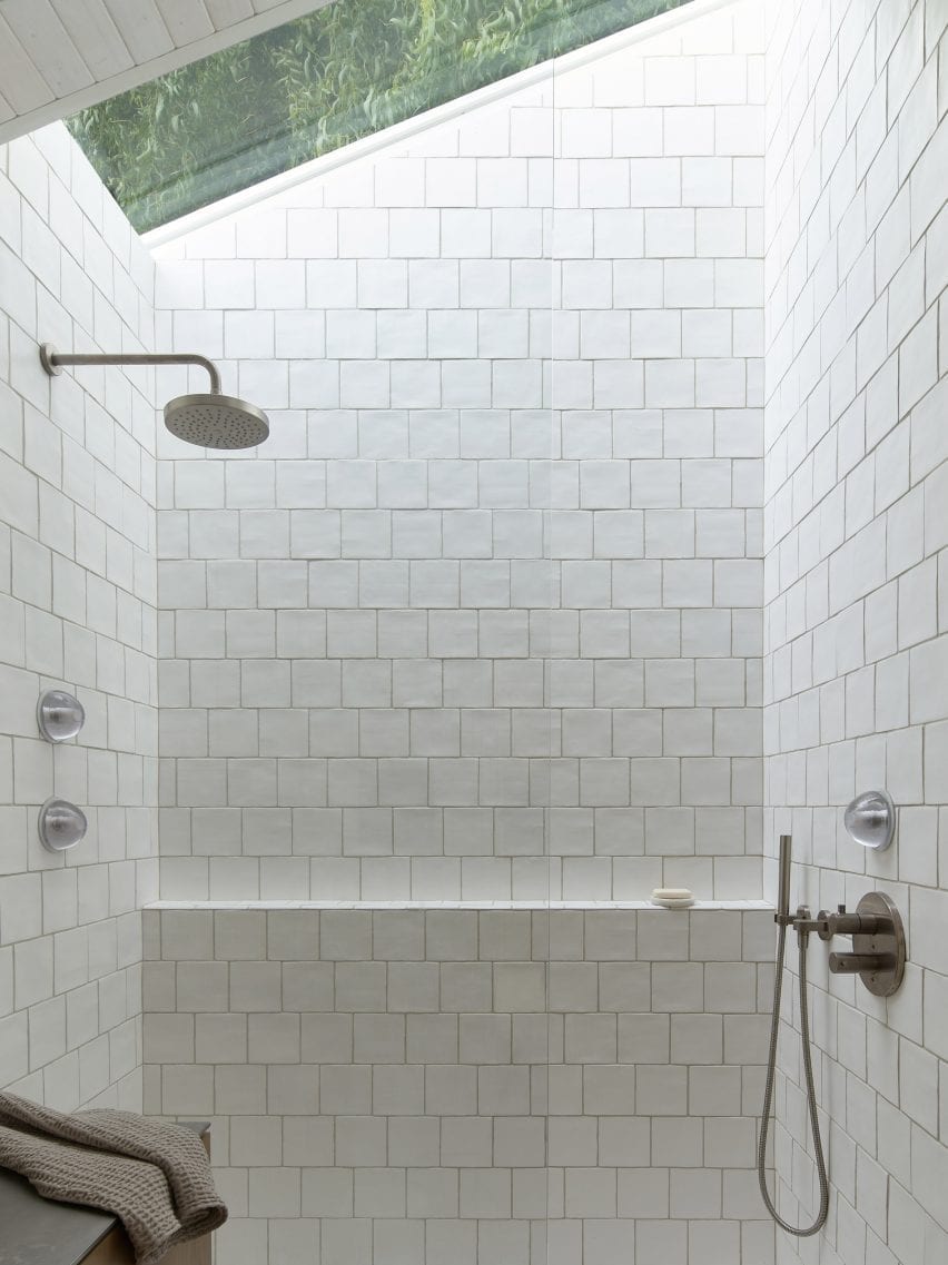 White-tiled shower in The Portage Bay Float Home