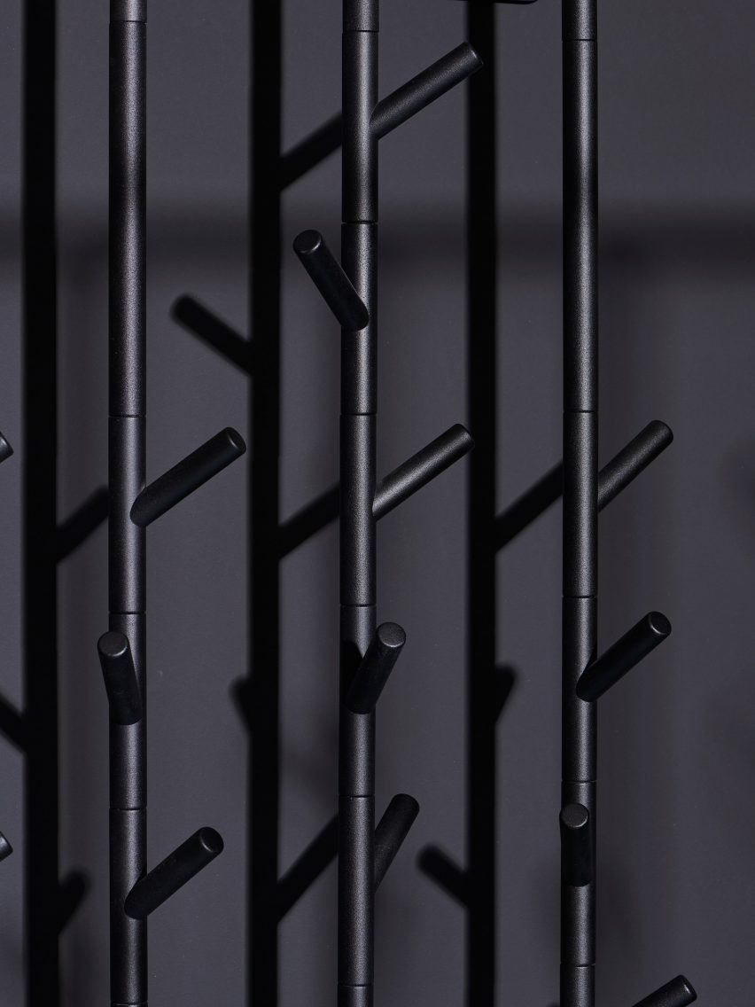 Branch-like hooks on a black coat stand 