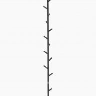 A wall-mounted coat stand with branch-like hooks