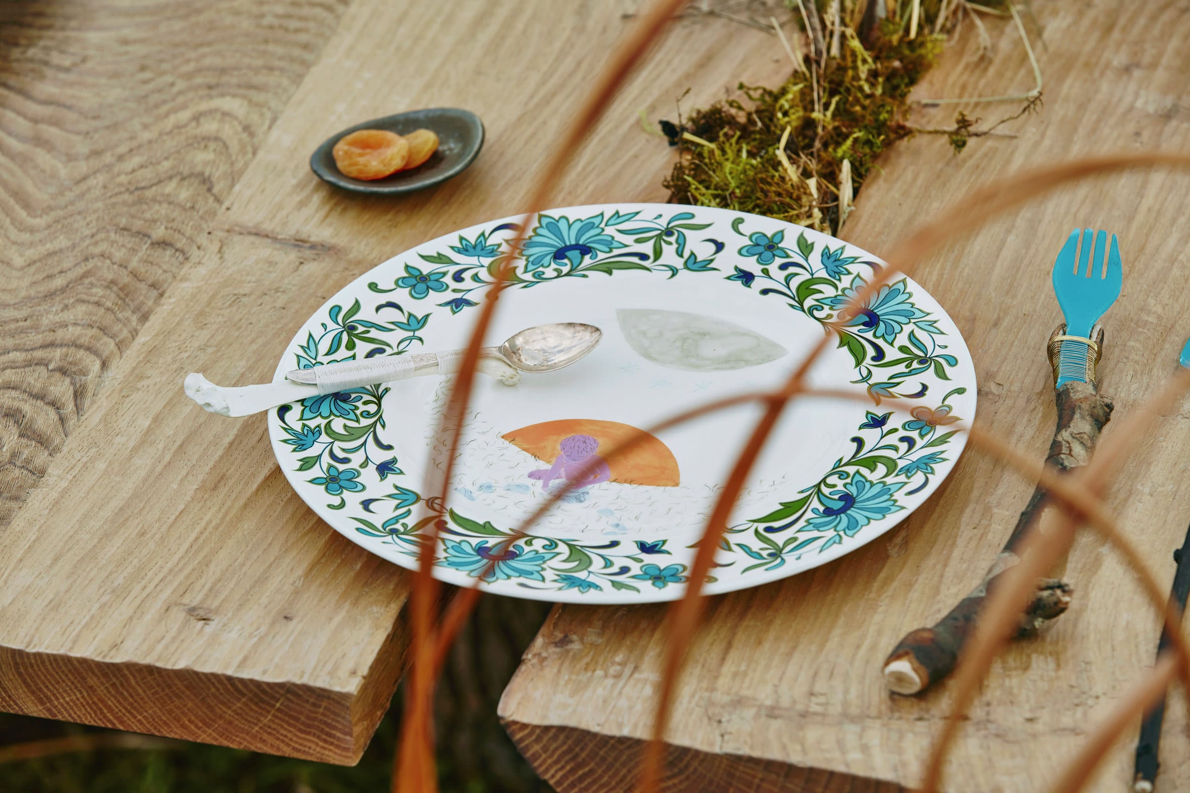 Close-up of table setting with illustrated ceramic plate in Venice Architecture Biennale installation by Superflux