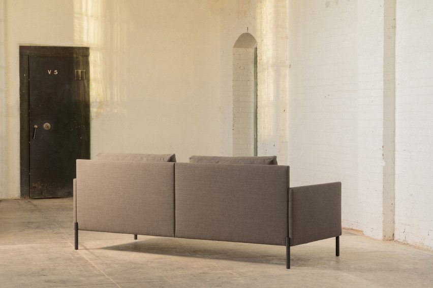 A straight back sofa with grey upholstery by Part & Whole