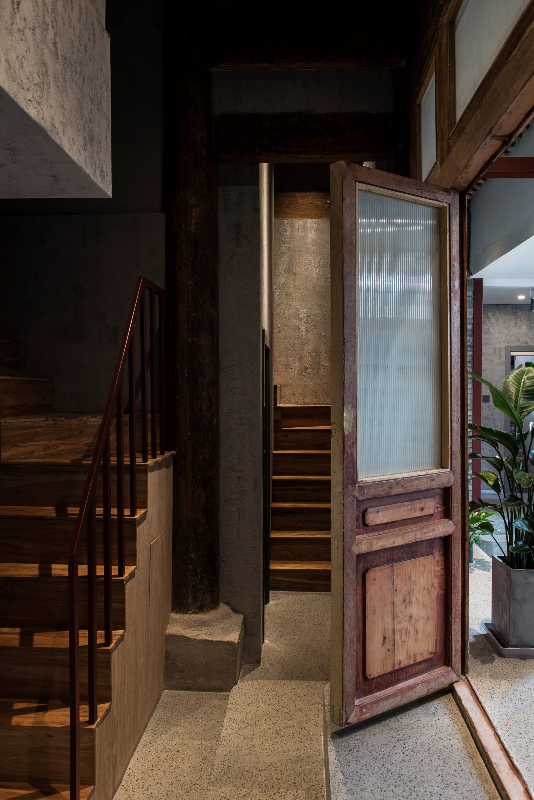 Entrance with wooden door and stairs to renovated hutong hotel by Fon Studio