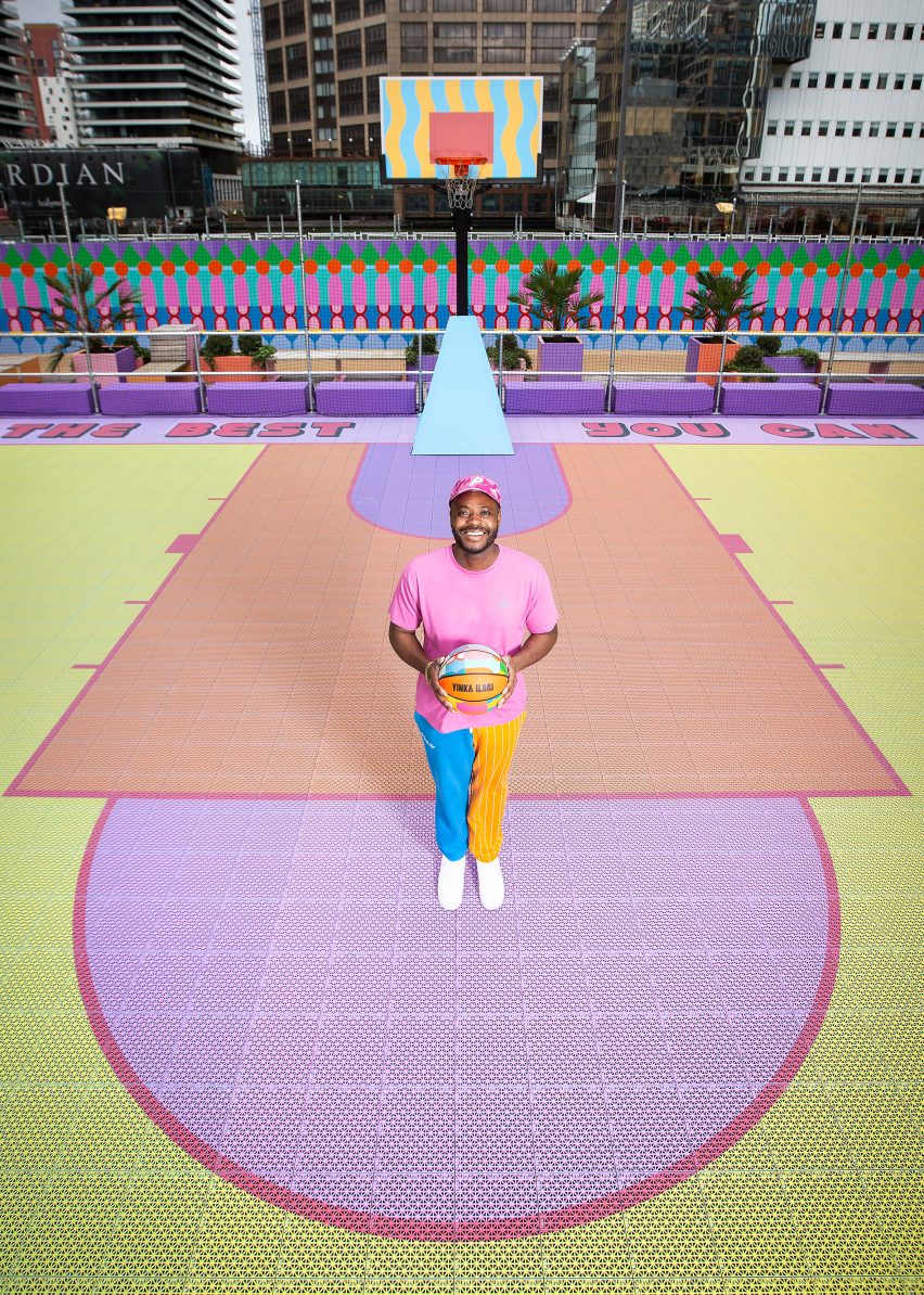 Aerial view of Yinka Ilori on colourful Canary Wharf basketball court