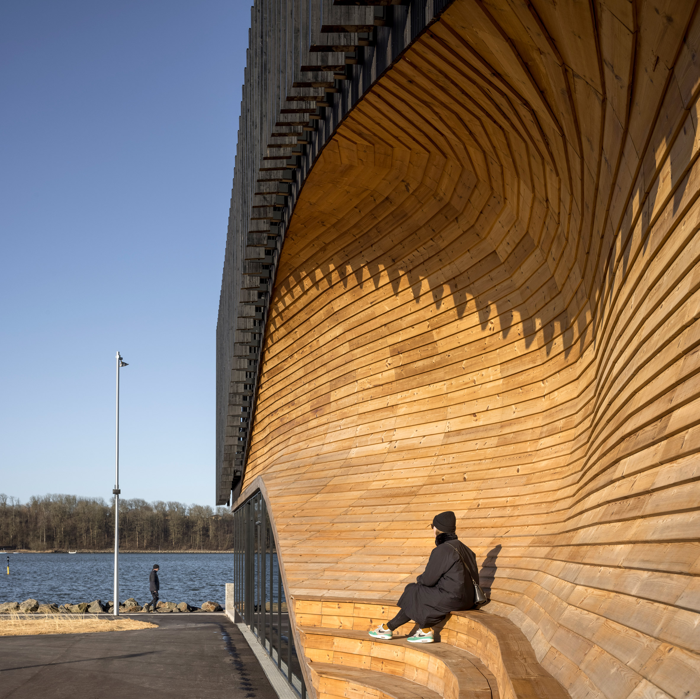 A wooden facade with integrated seating