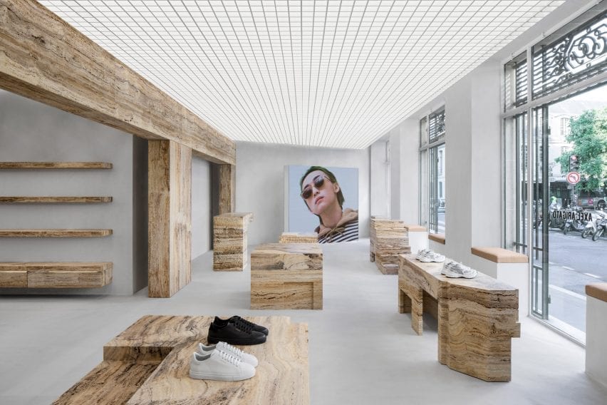 Retail interior by Halleroed with shoes displayed on travertine blocks