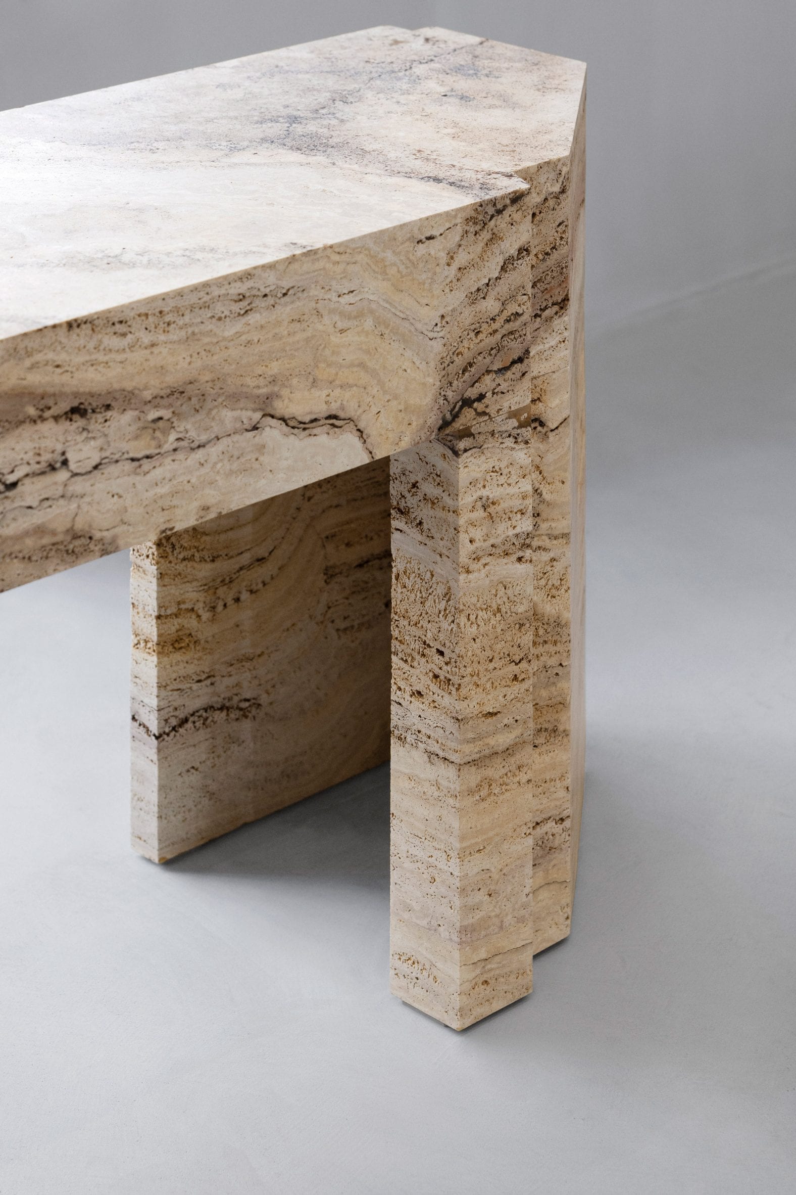 Close-up of travertine stone table in Axel Arigato Paris store 
