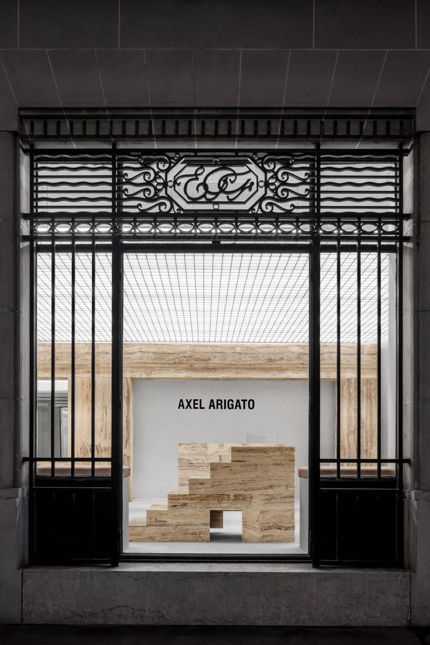 Entrance to Axel Arigato Paris store with travertine displays
