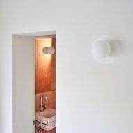 The bathroom is accessed by an opening in a wall