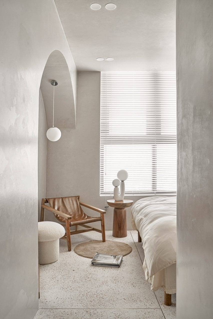White bedroom with sculptural wooden furniture