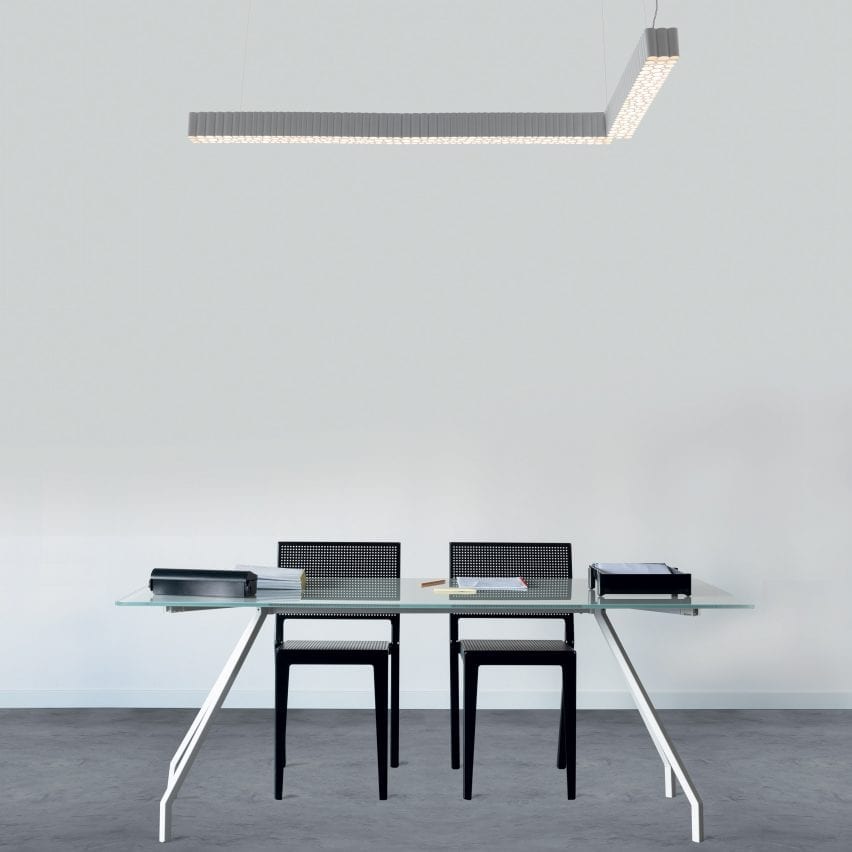The Calipso light hanging above a table and chairs