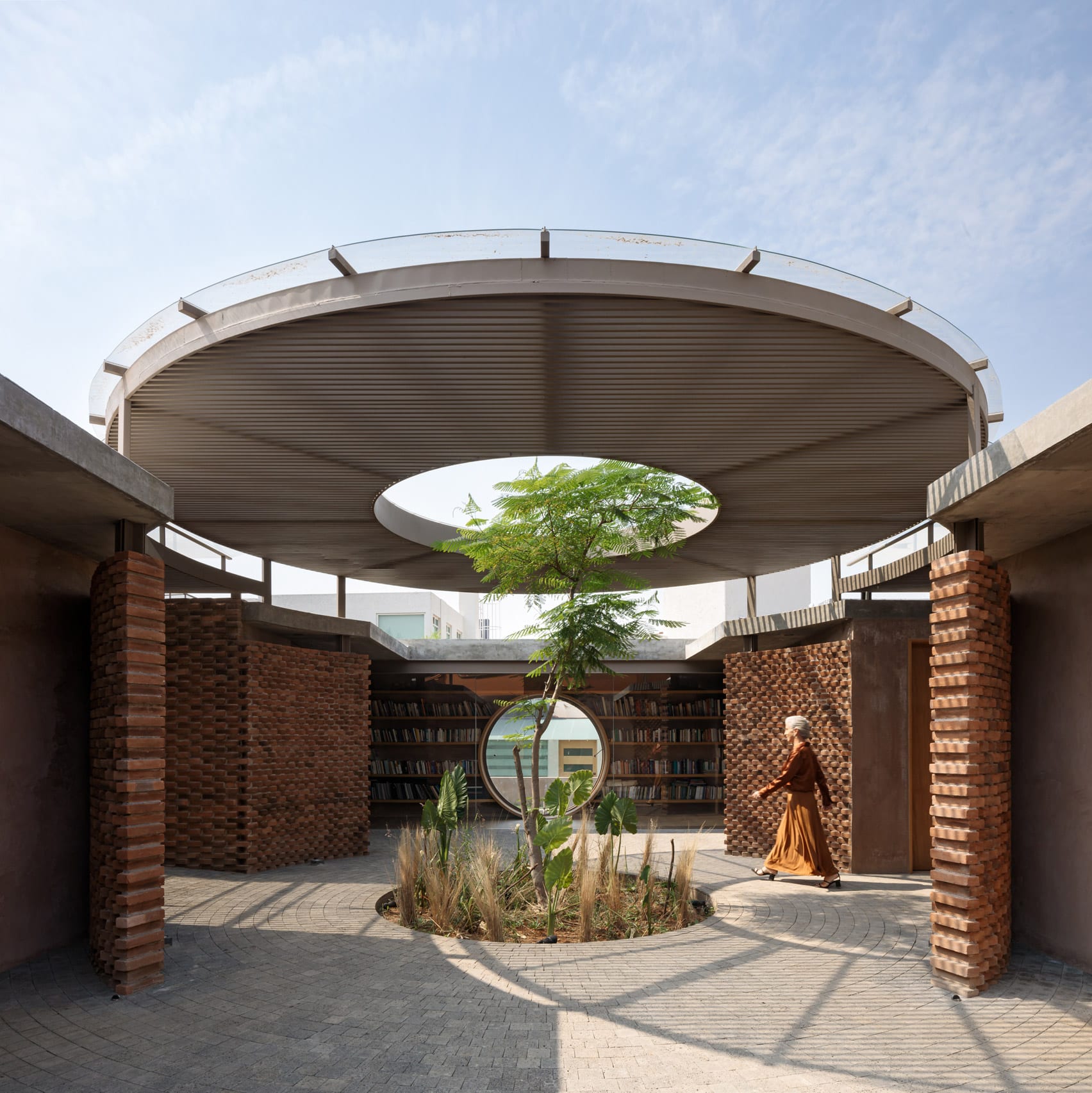 Tree growing through oculus in a courtyard canopy of a house in Mexico