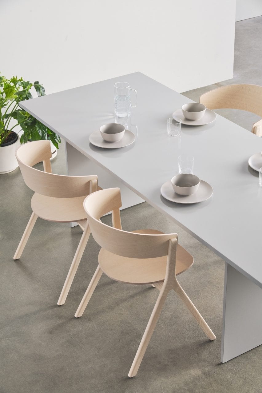 Wooden chairs around a grey table