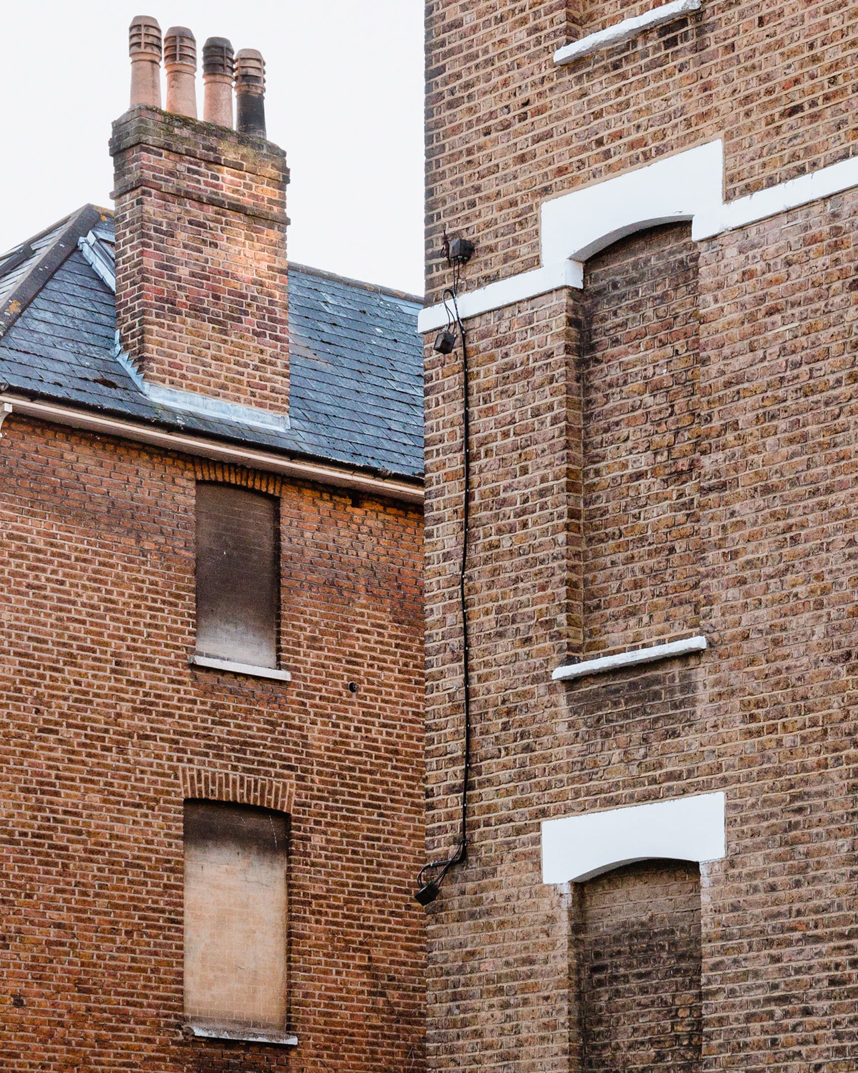 Brick houses in London with covered windows