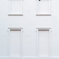 A windowless white facade