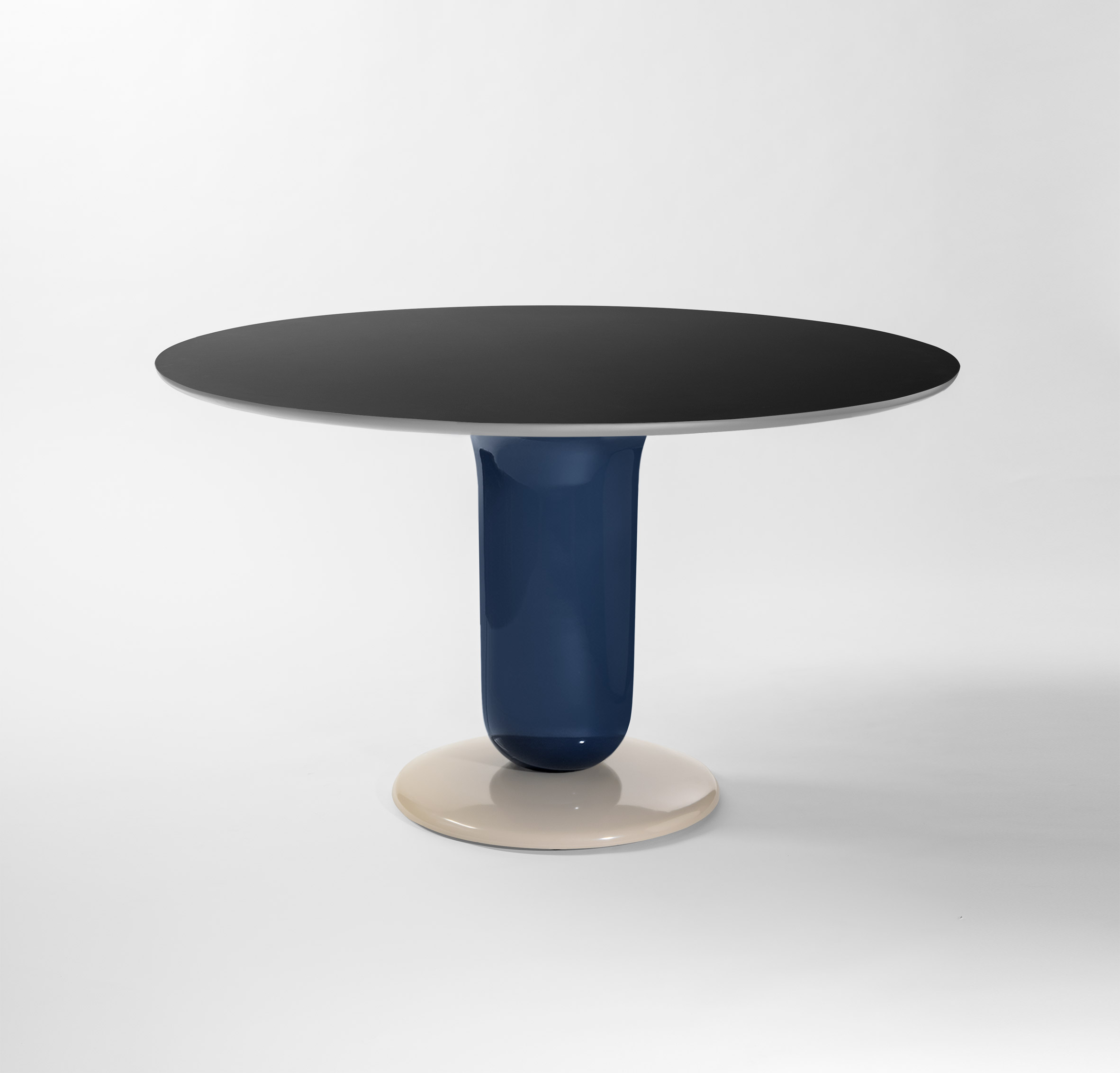 A pedestal dining table with a circular top