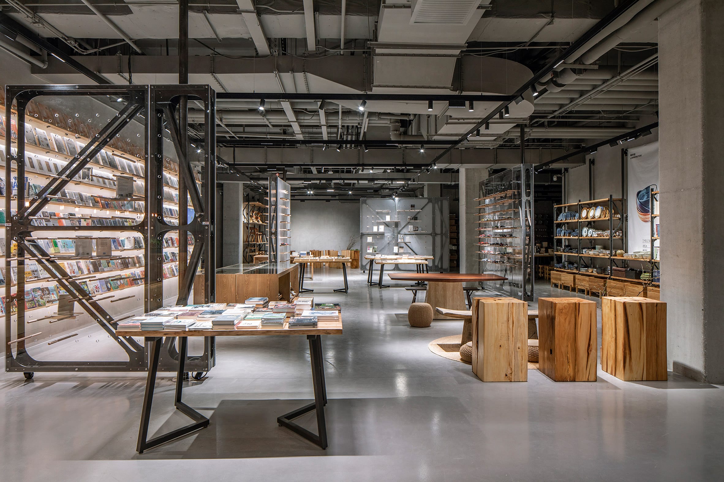 Bookstore with wooden display stands and clear dividers by LUO Studio