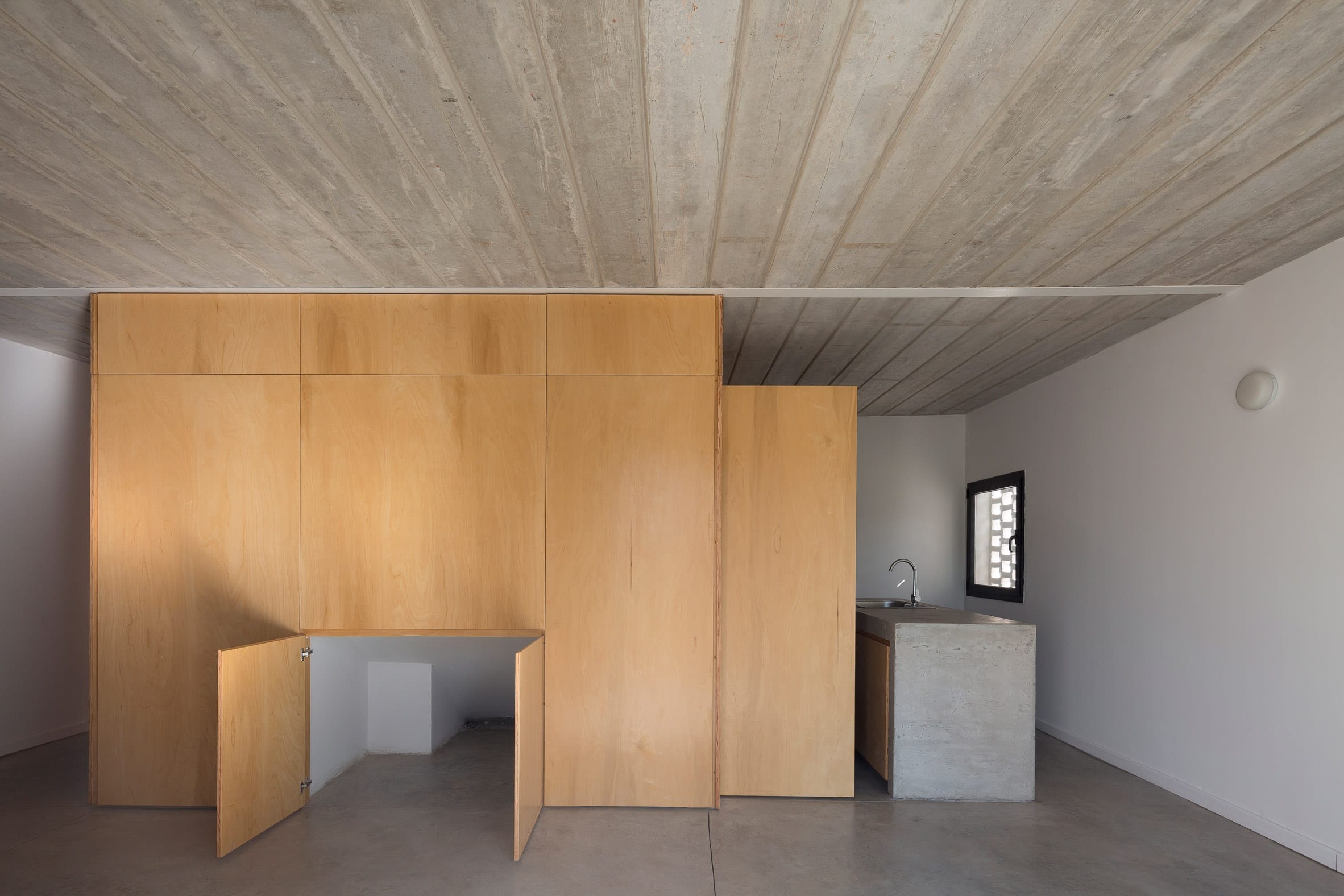 Interior of brick house with plywood centre