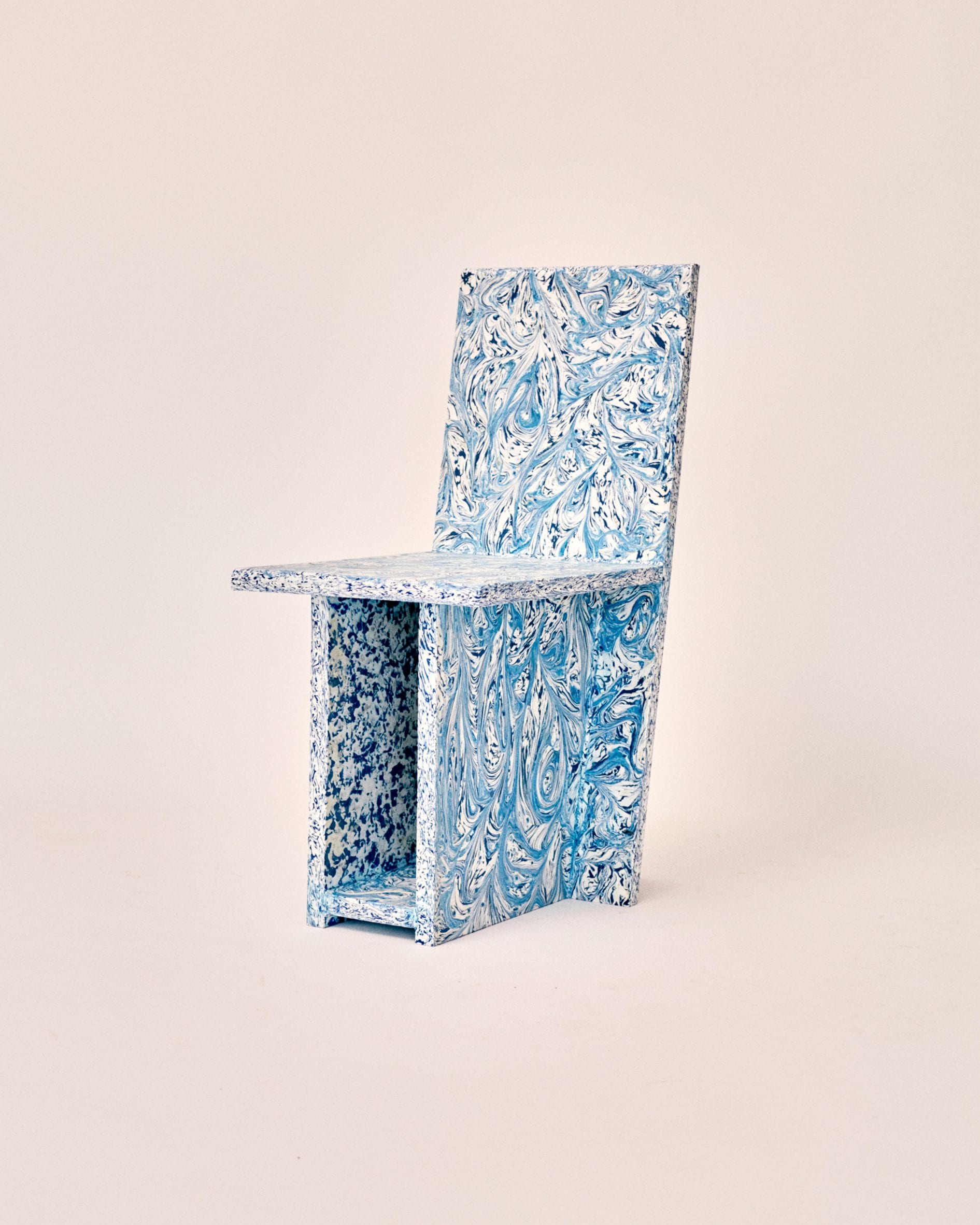 Side view of speckled blue plastic chair by Peggy Gou and Space Available