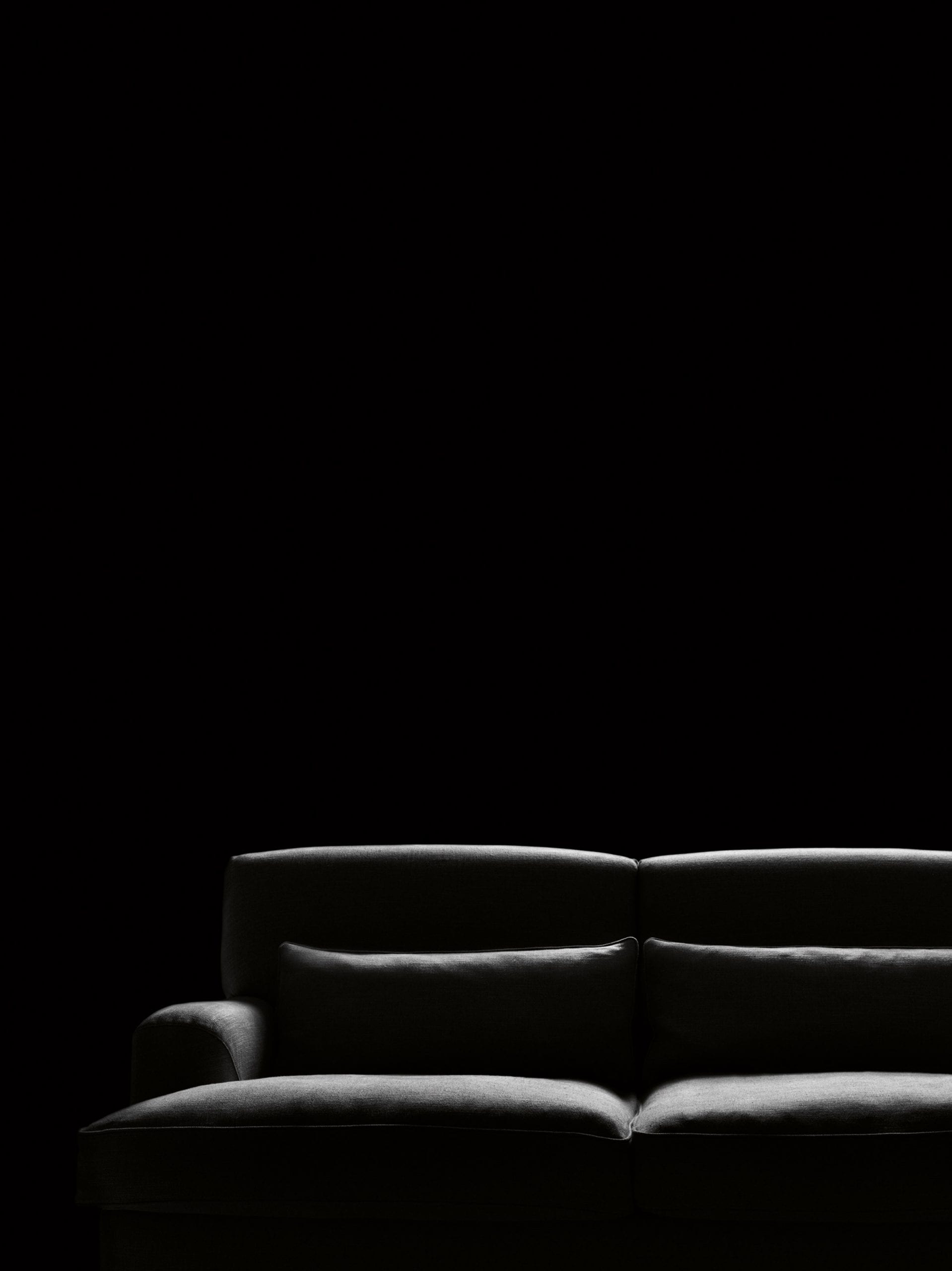 Black sofa by Boffi on a black backdrop