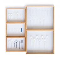 There is a cabinet with white cutlery