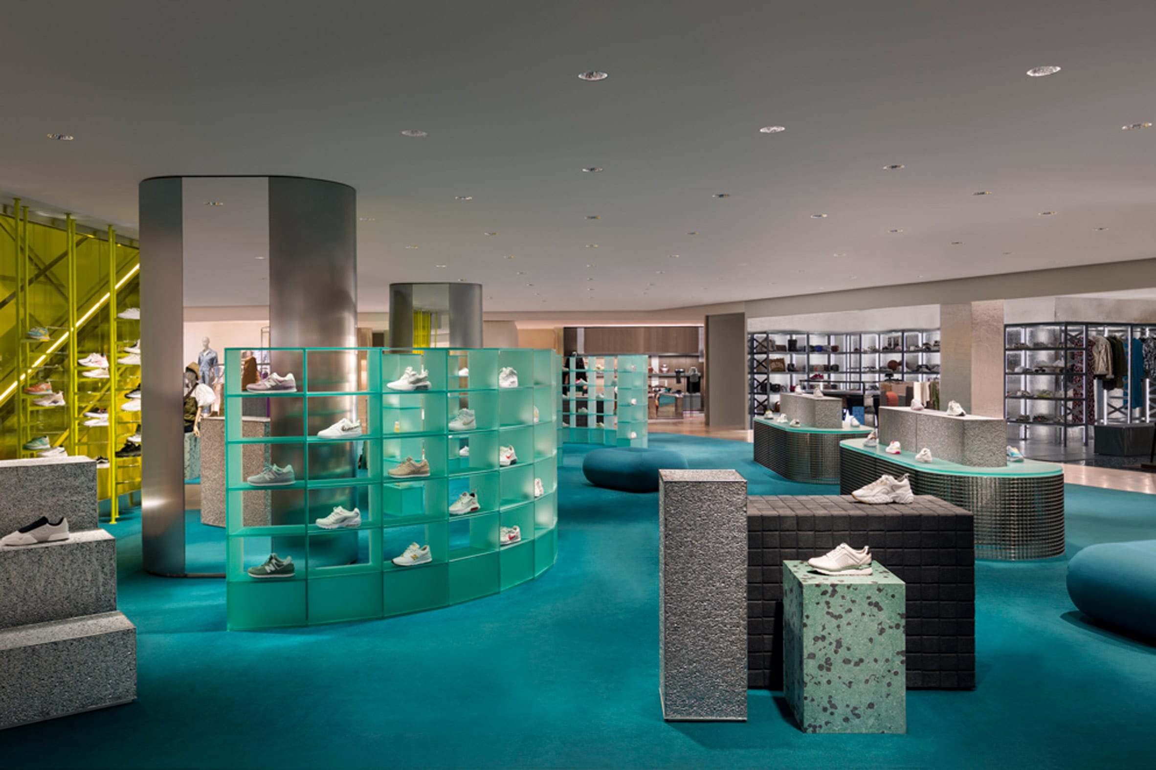 Overview of La Rinascente womenswear department with blue carpet and grey displays