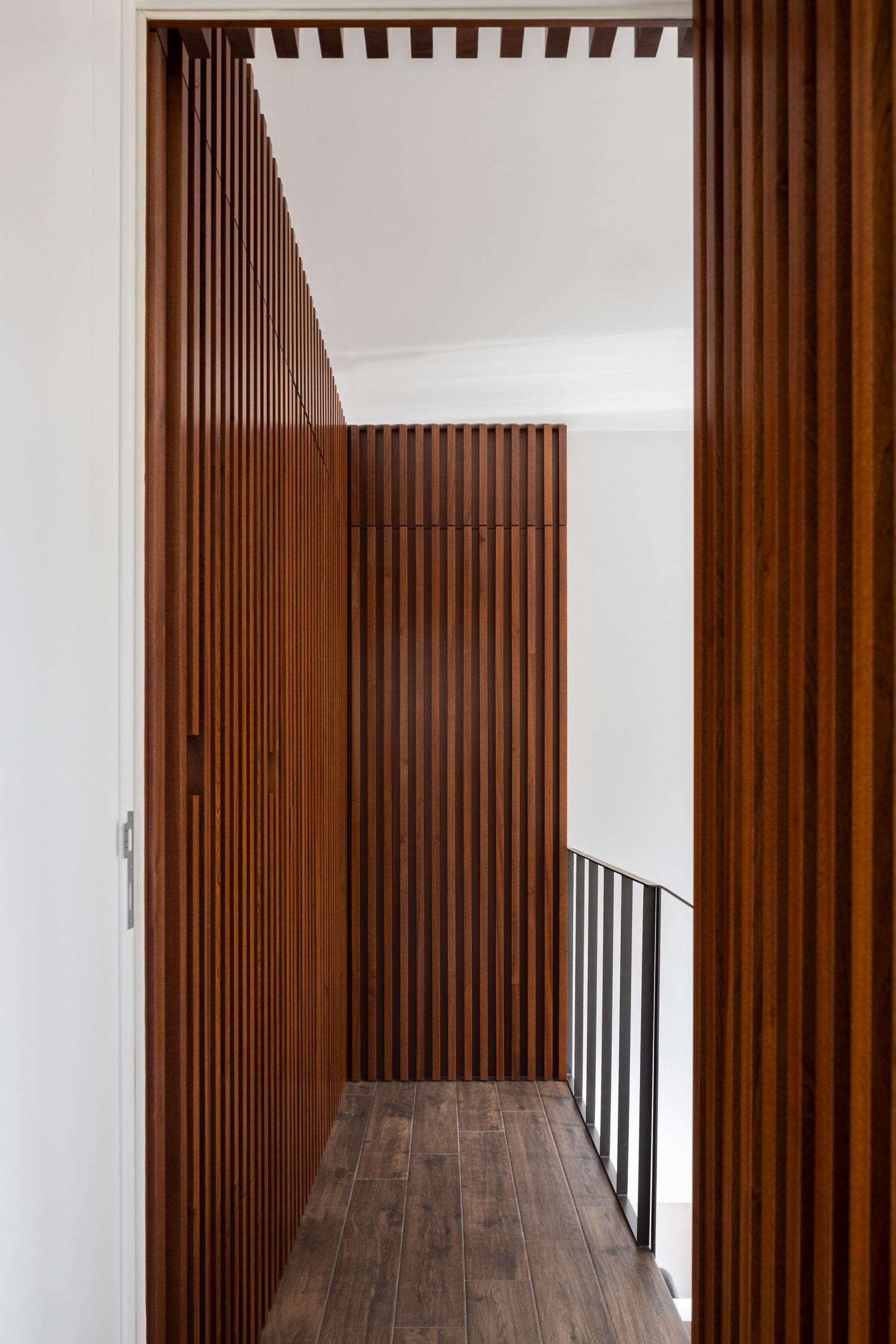 Stained wood was used throughout the home by Tiago Sousa