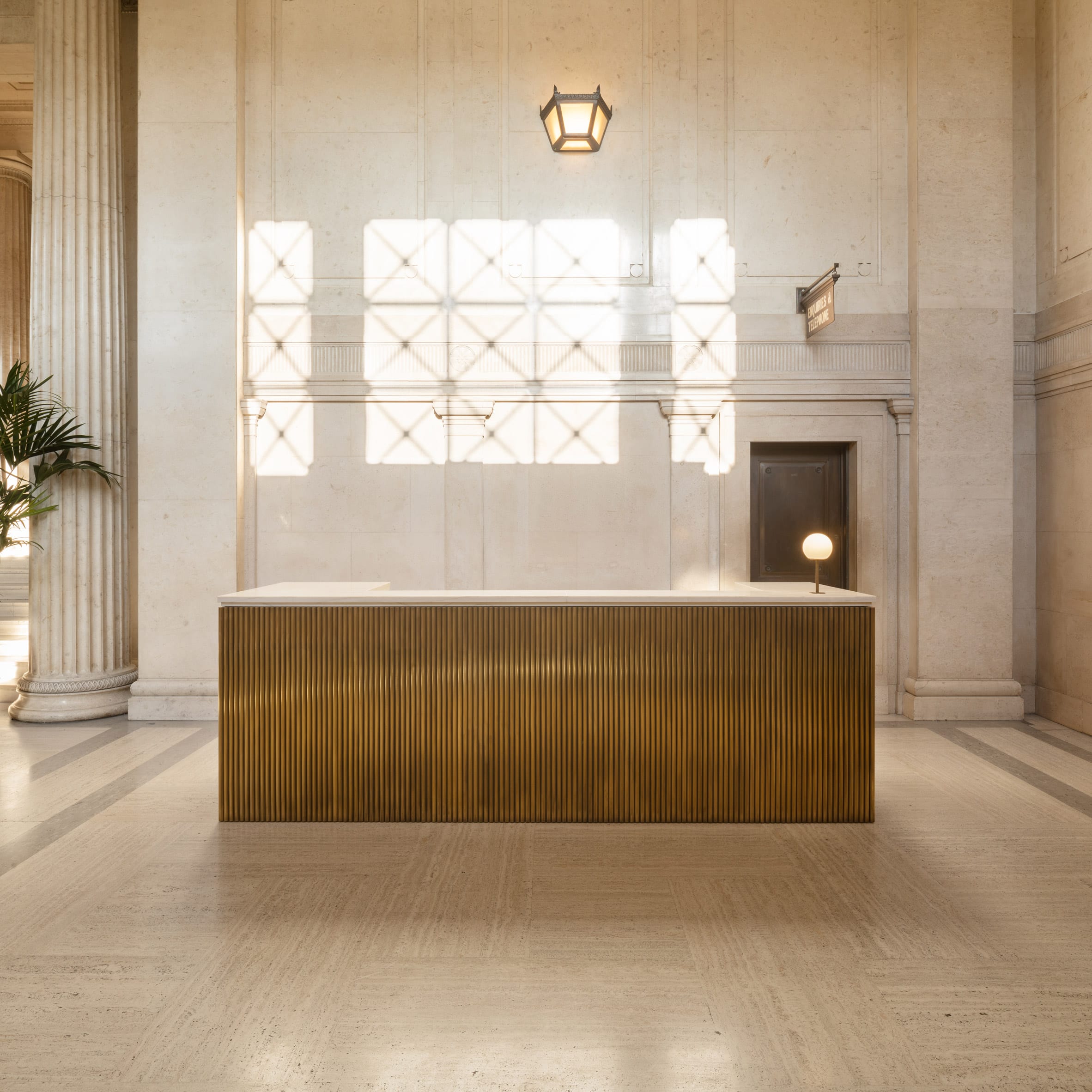 Gold-coloured counter with orb light in Victoria House office interior