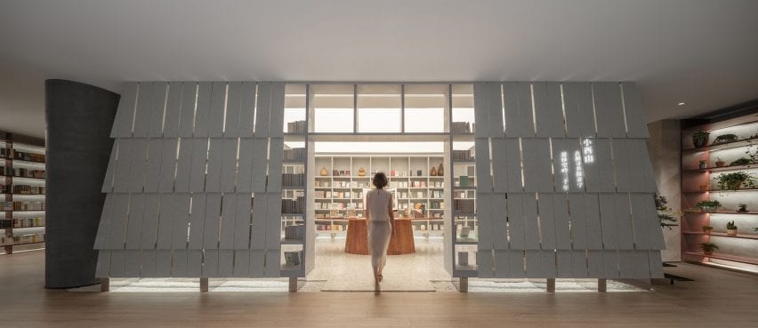 Wutopia Lab installed a bookshelf formed from white panels