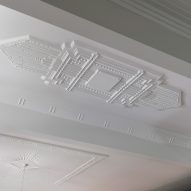 Mouldings cover the ceiling