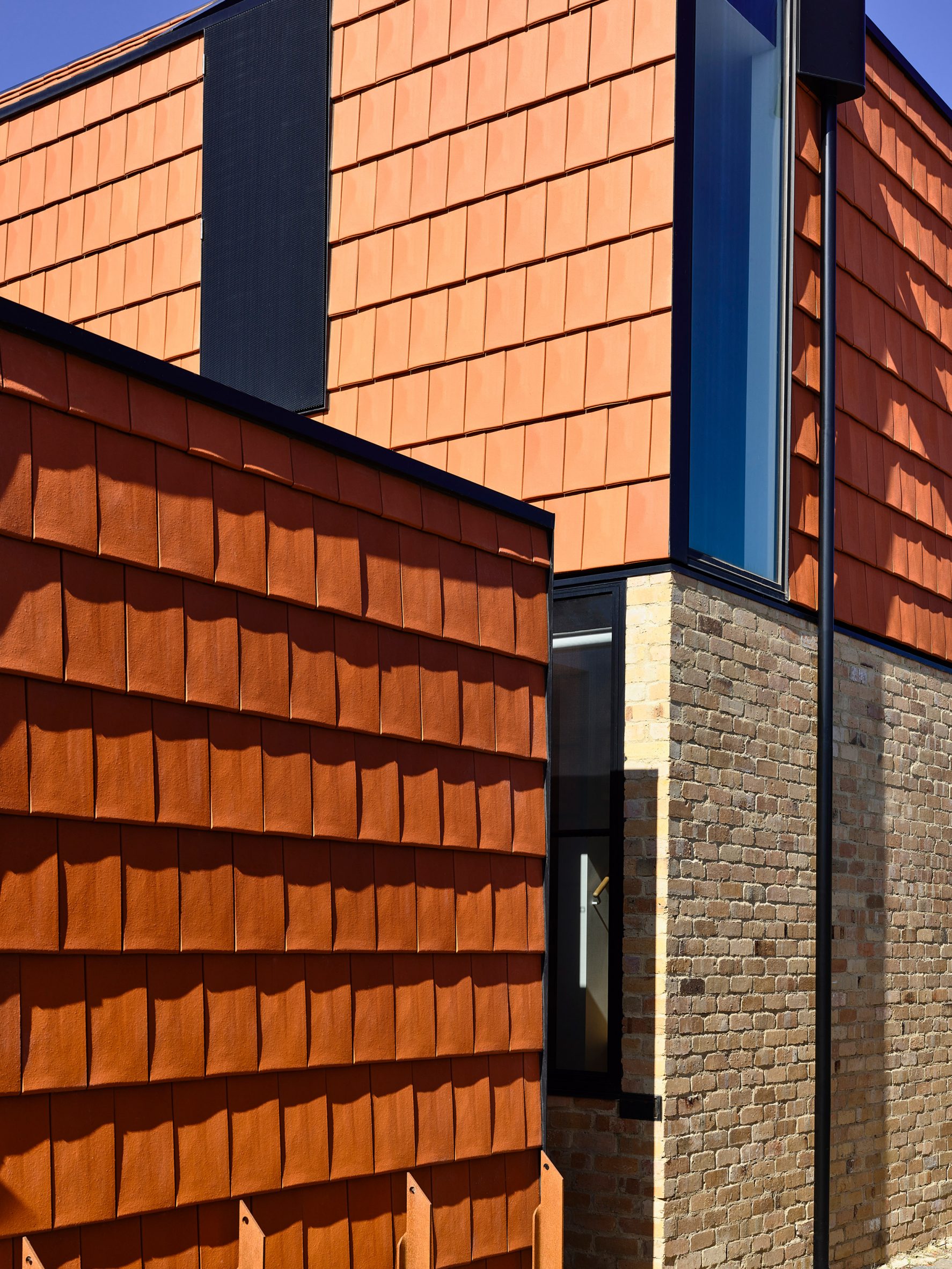 Recycled brick clads the exterior of terracotta house