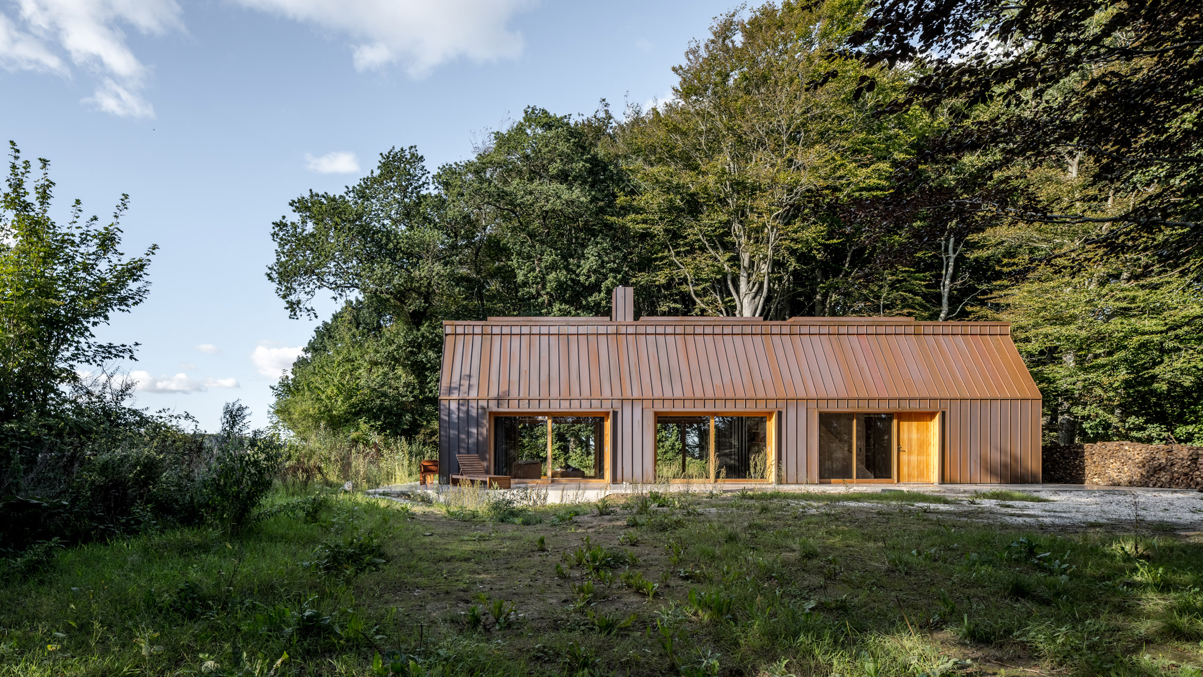 The Author's House is a copper-clad cabin in a Danish forest