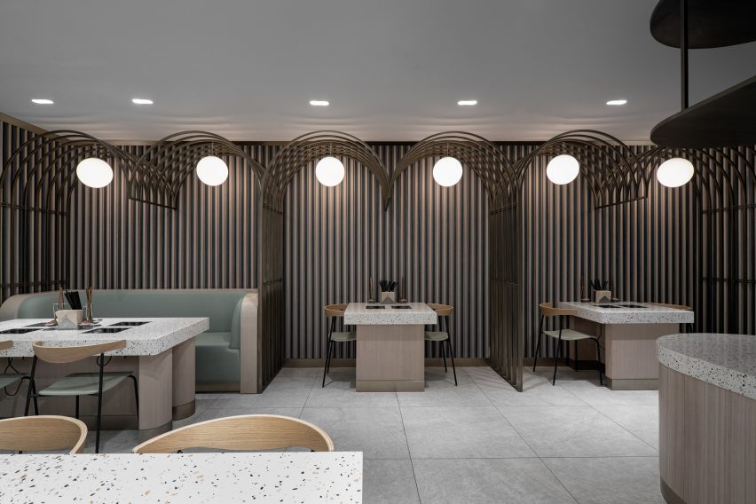 Hotpot restaurant by SHH with metal arches over seating areas