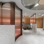 Arched glass panels suggest windows in basement canteen by SHH