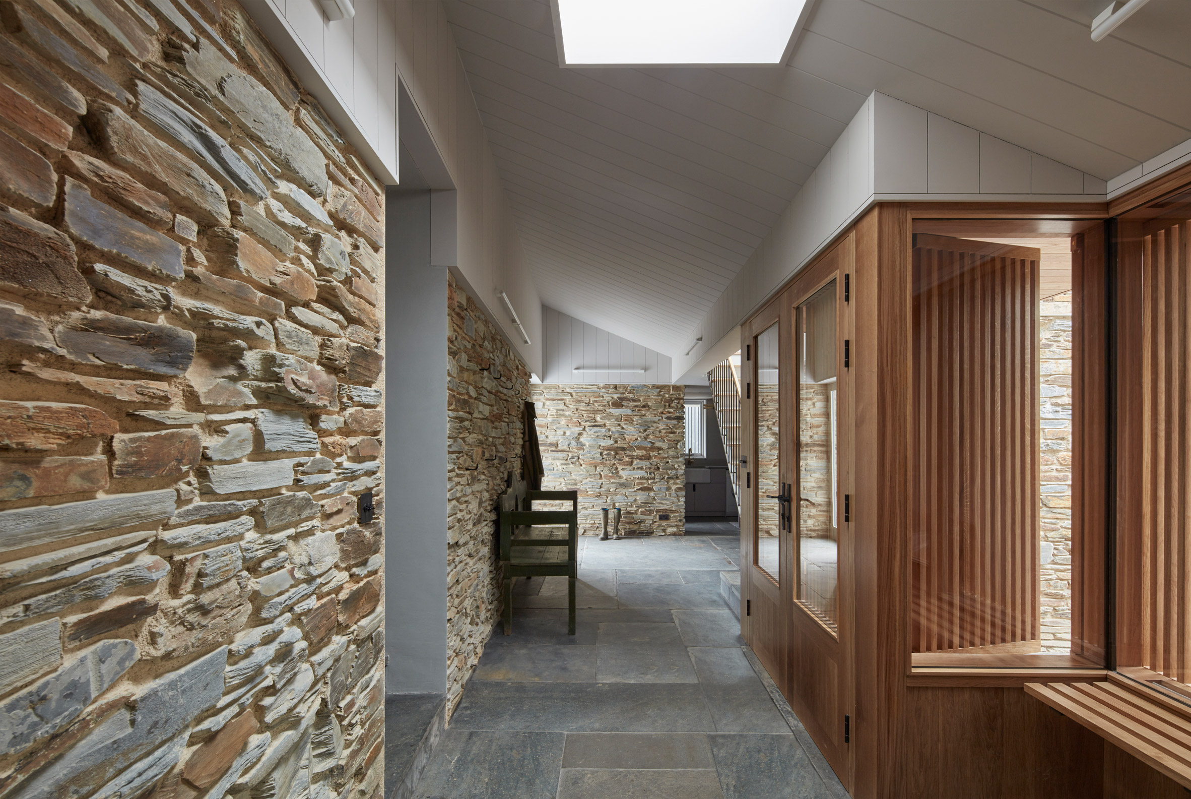 A hallway with a stone wall