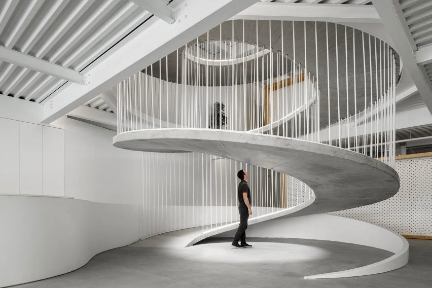 Base of spiralling concrete ramp in E-goi and Clavel's Kitchen by Paulo Merlini Architects