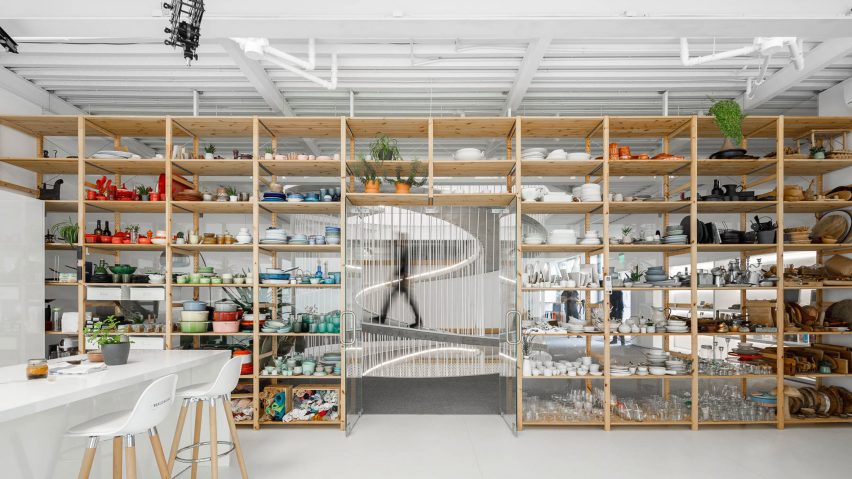 Storage wall filled with colourful ceramics in E-goi and Clavel's Kitchen by Paulo Merlini Architects