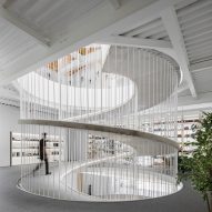 Paulo Merlini Architects creates concrete spiral walkway inside Porto office