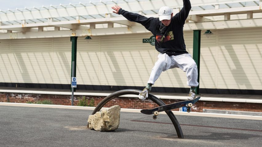 Skater performing a trick on a rainbow-shaped sculpture by Assemble at the Folkestone Triennial 2021