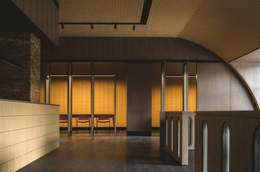Buda Hotel lobby with counter and curved ceiling clad in yellow tiles