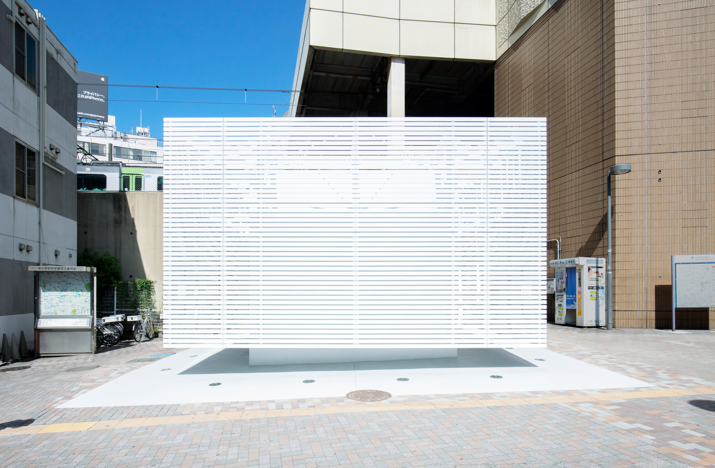 Toilet block wrapped in white louvres