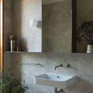 A bathroom with stone tiles