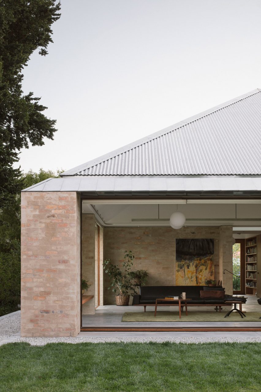 A brick house with a corrugated steel roof