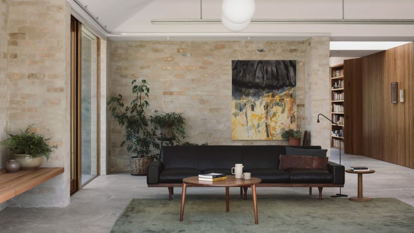 A living room with brick walls and pitched ceilings