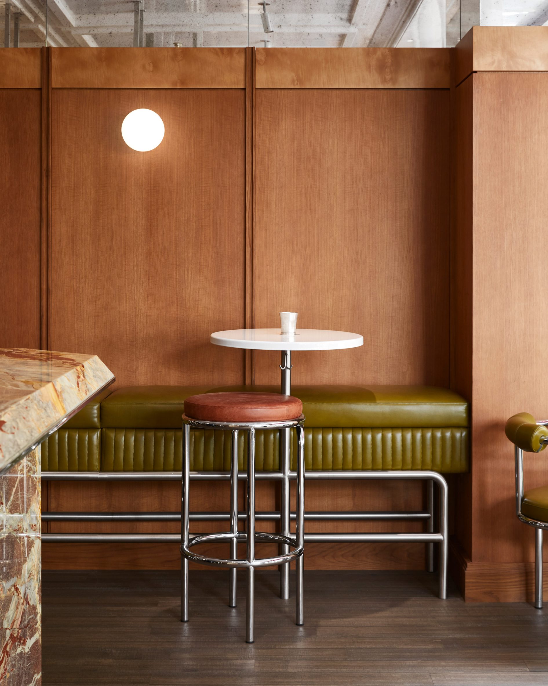 Wood panelling and green leather bench in Abstinence restaurant