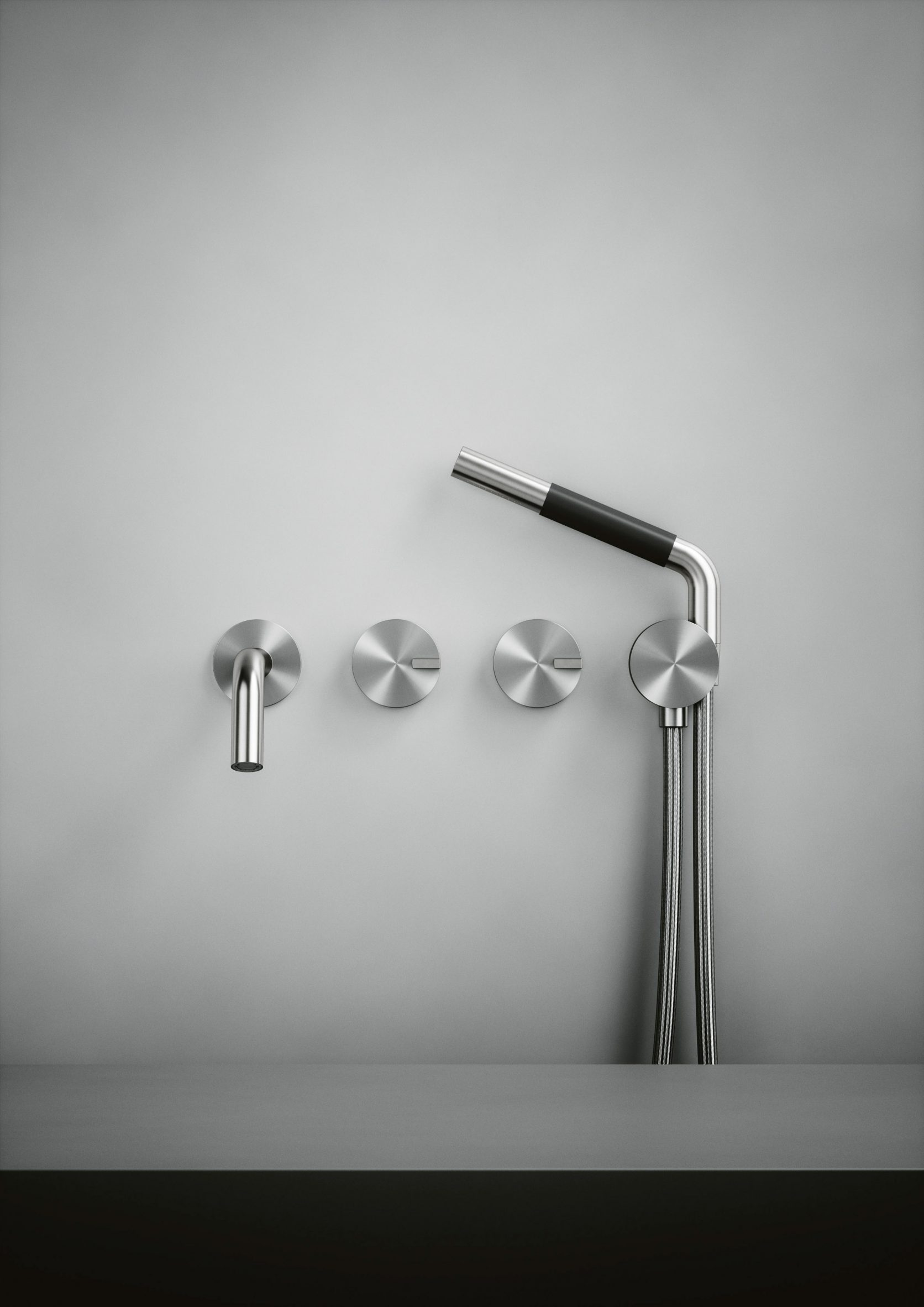 A silver showerhead and bath tap