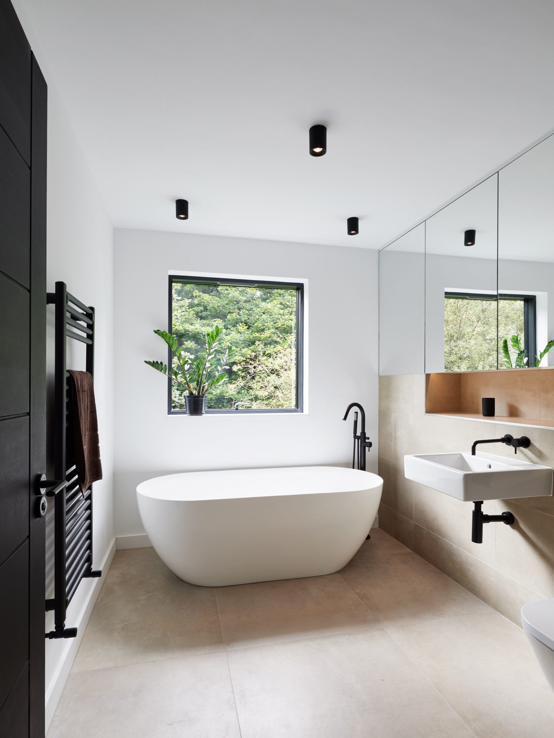 A white bathroom with a freestanding tub
