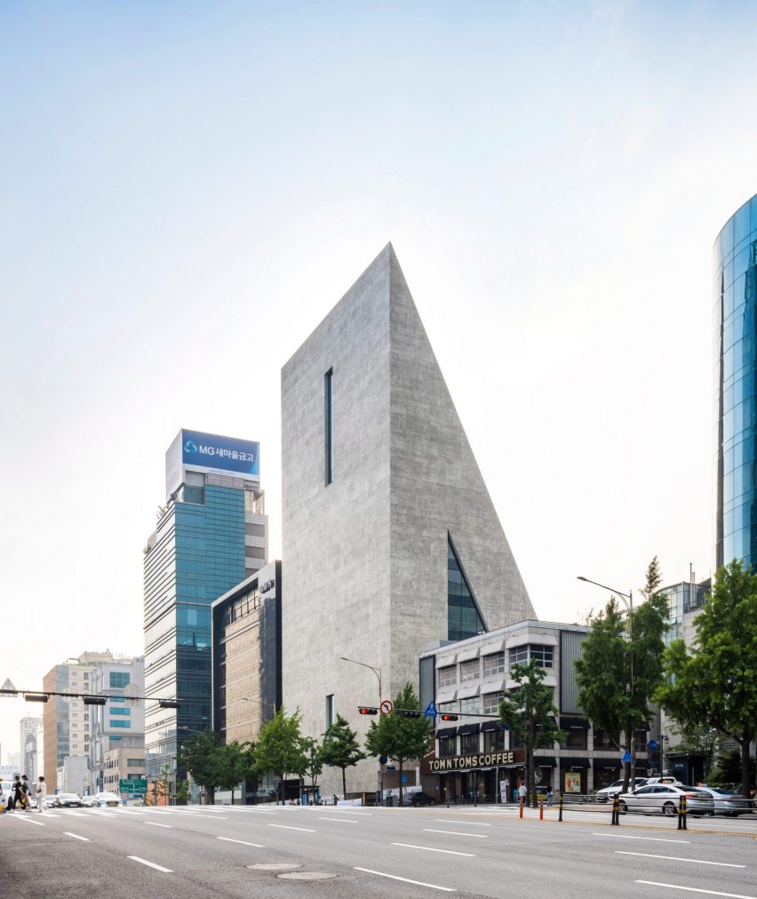 A triangular concrete building by Herzog & de Meuron