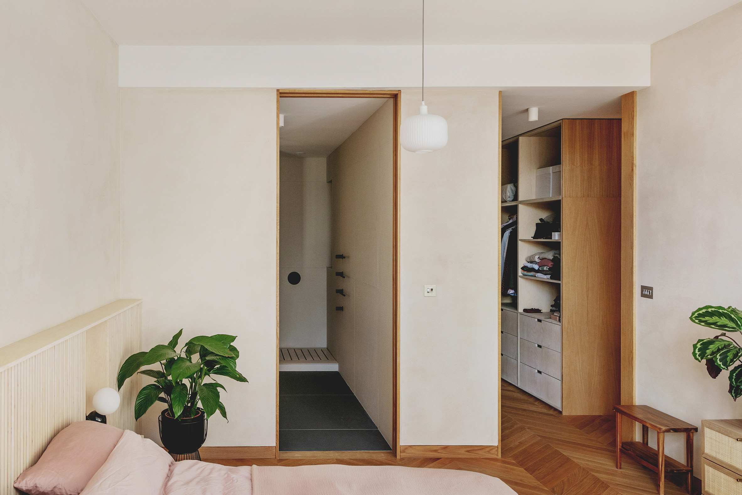 Main bedroom with en-suite and walk-in-wardrobe in St John Street warehouse apartment by Emil Eve Architects